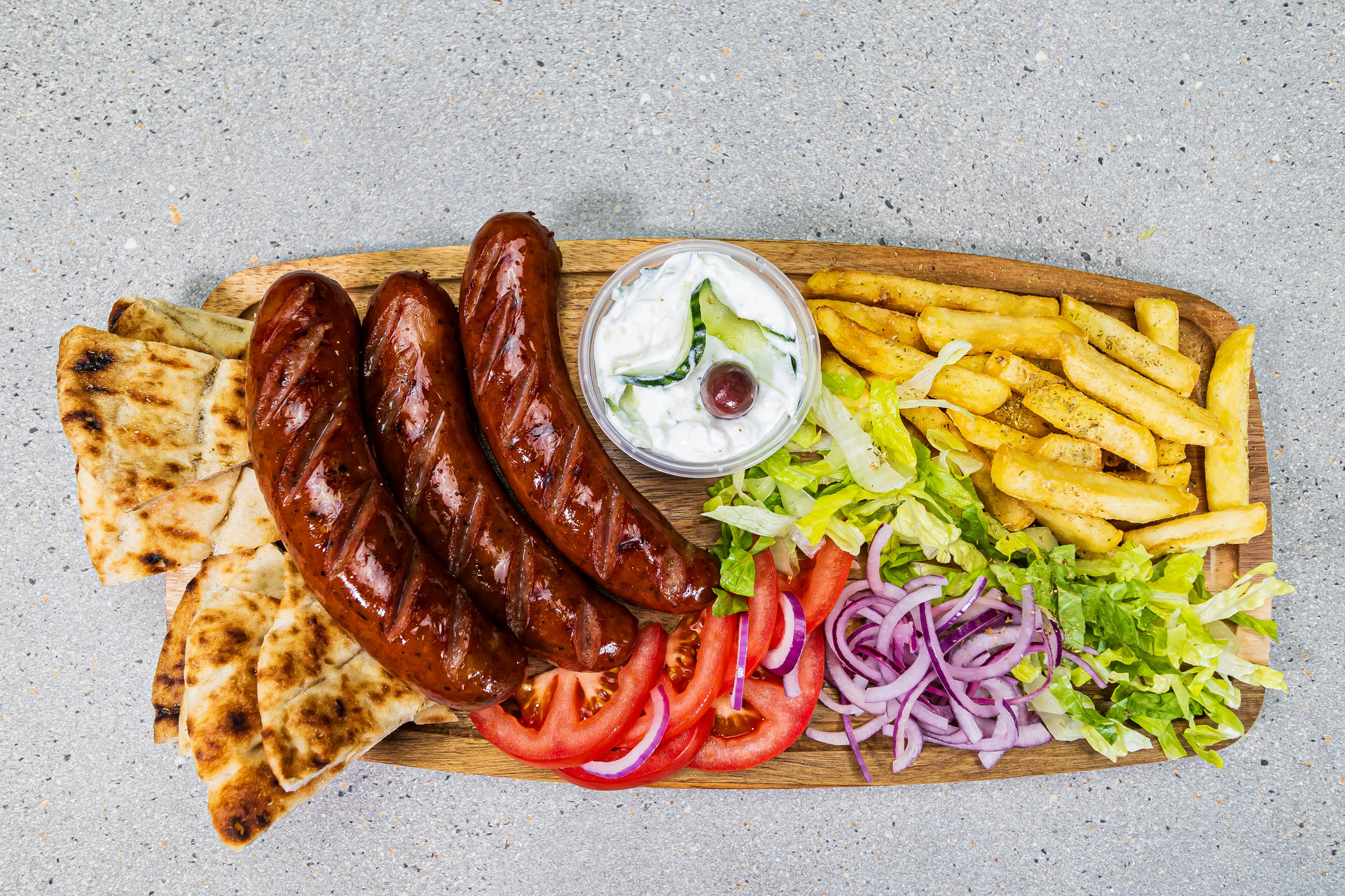 3 Greek sausage skewers served with pitta bread, french fries and homemade tzatziki – Cristina's Greek Souvlaki Daventry